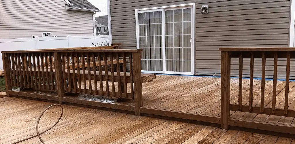 Deck sealing service protecting a backyard wood deck and railings in Arvada, CO