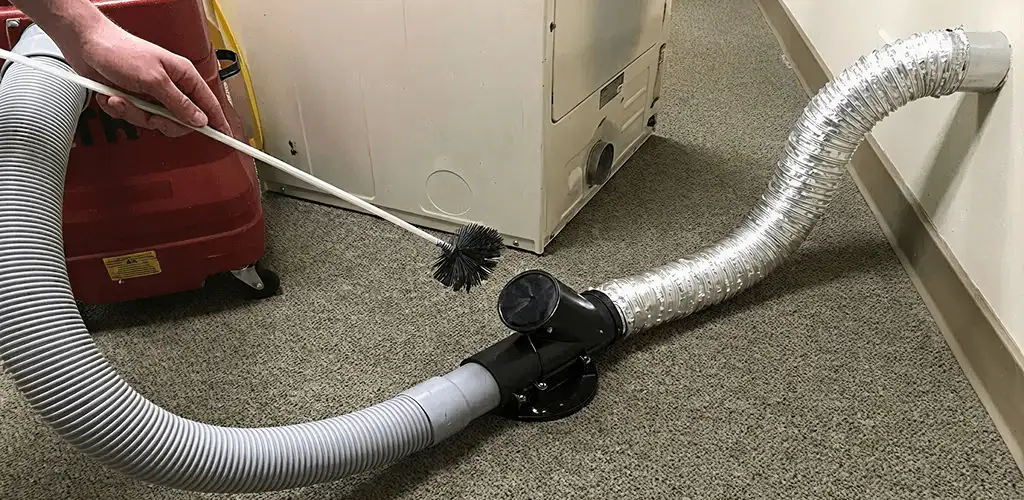 Dryer vent cleaning service removing lint from a dryer duct connection in Arvada, CO