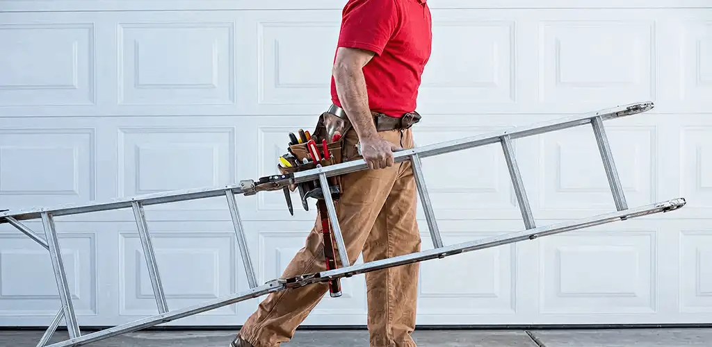 Garage door repair technician arriving with tools and ladder in Arvada, CO