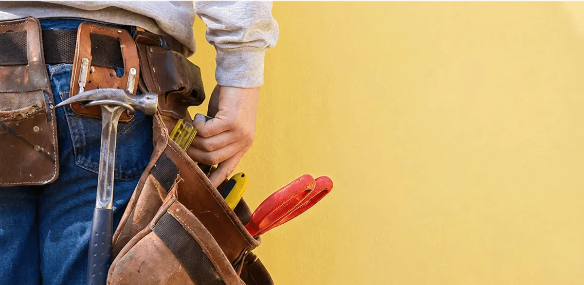 Handyman with tool belt ready for home repairs and maintenance in Arvada, CO