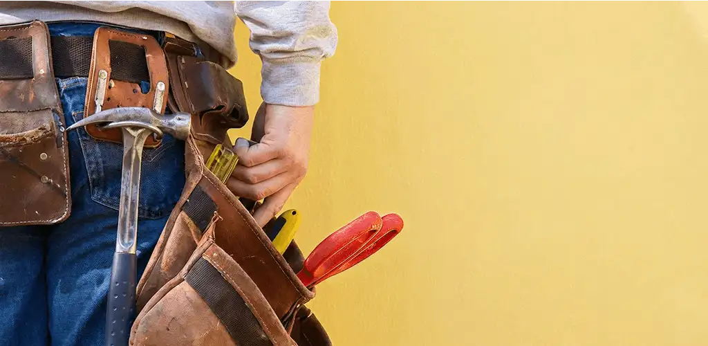 Handyman with tool belt ready for home repairs and maintenance in Arvada, CO